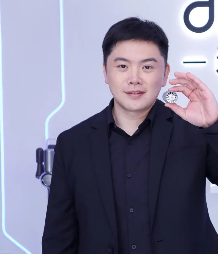Yu Hao, founder and CEO of Dreame, holding a high-speed motor component