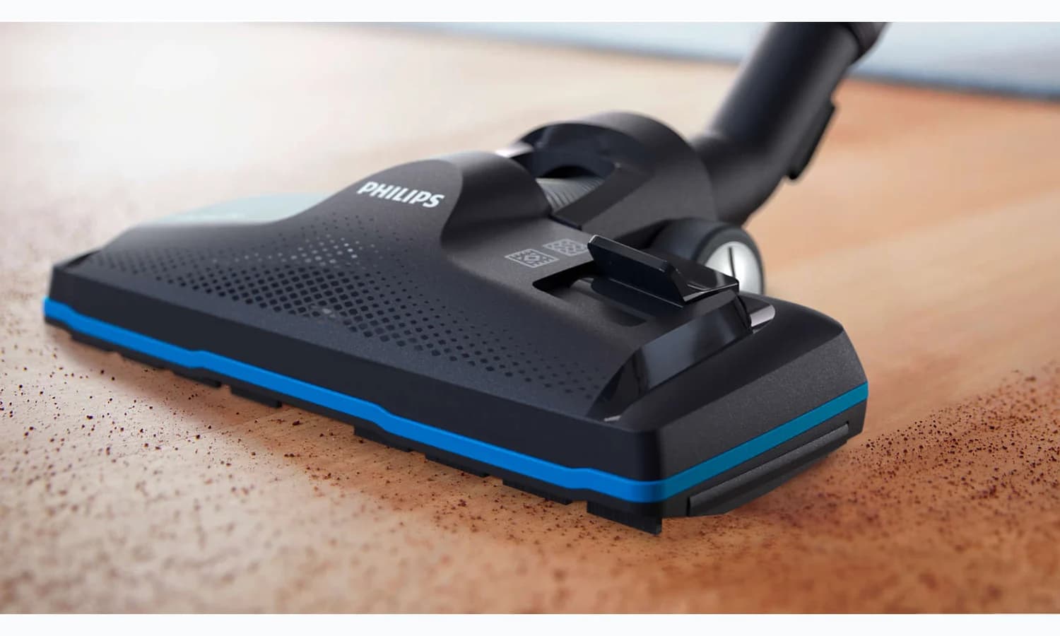 Philips TriActive Pro floor nozzle collecting debris from a hard floor