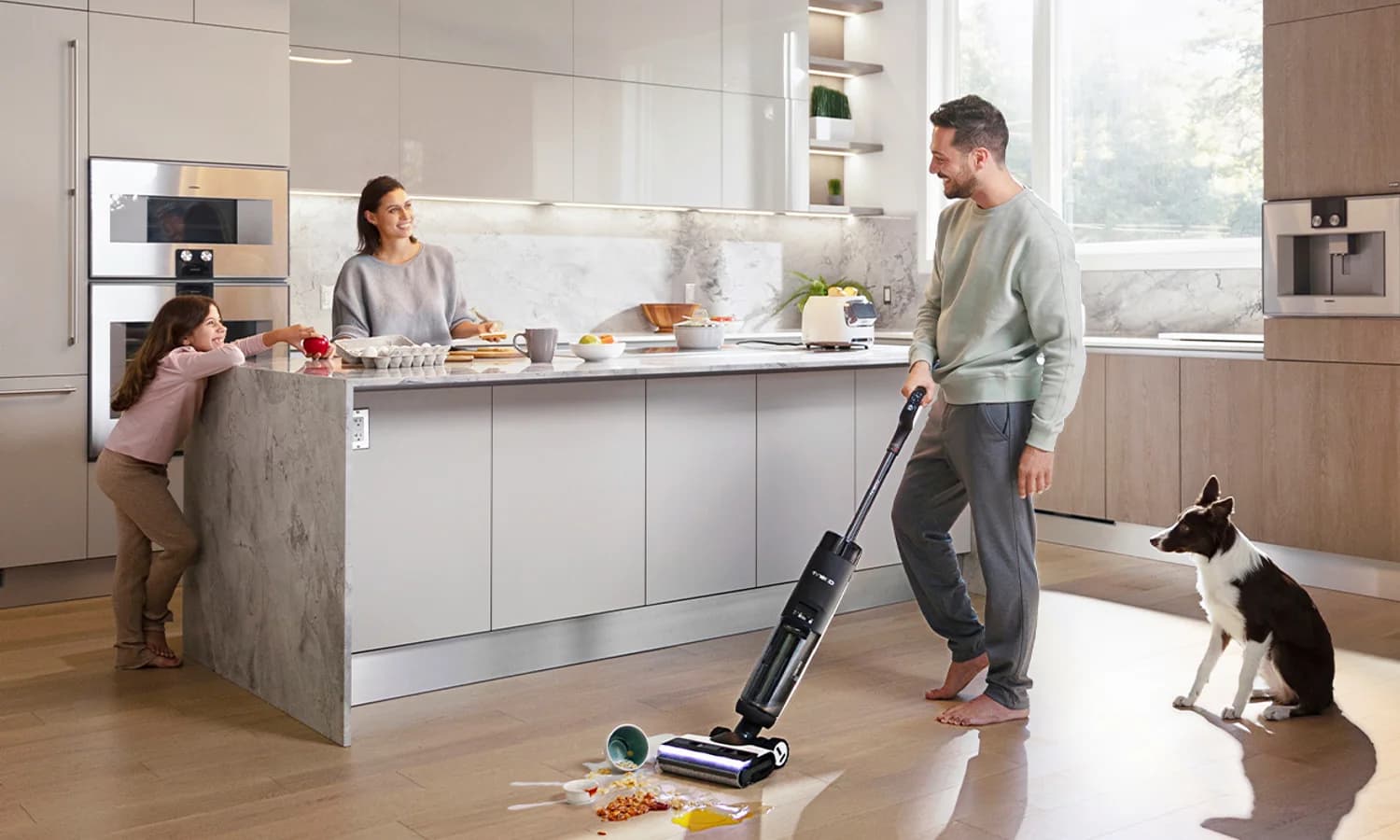 Person guiding a Tineco cordless floor washer toward a mixed spill on a hard floor