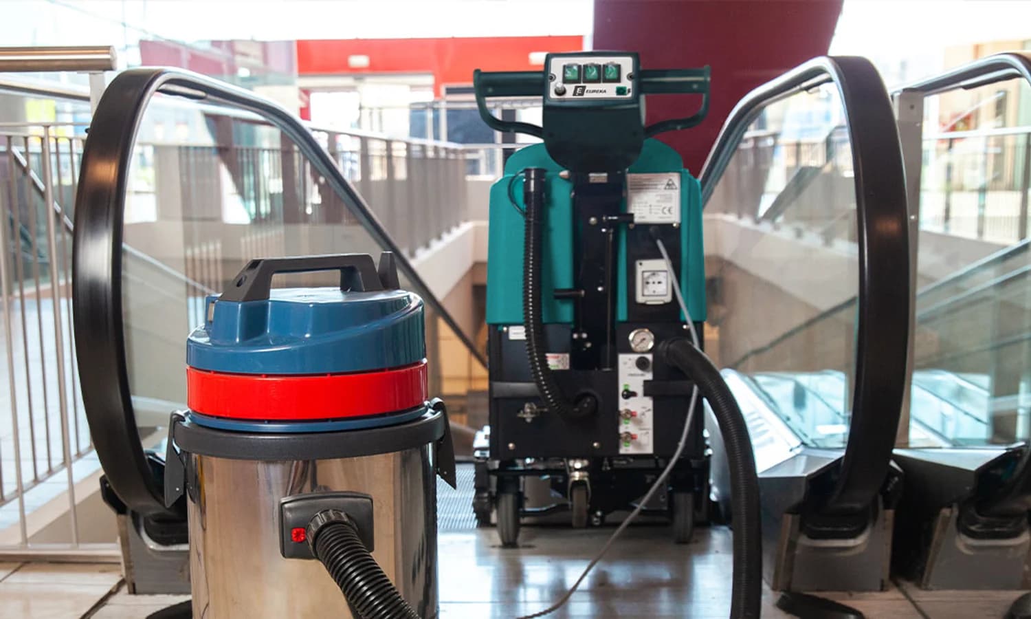 Eureka EC52 escalator cleaner and auxiliary vacuum at an escalator landing