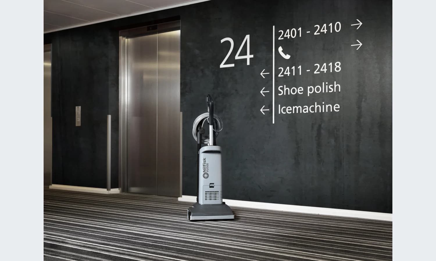 Nilfisk VU500 upright vacuum in a commercial corridor