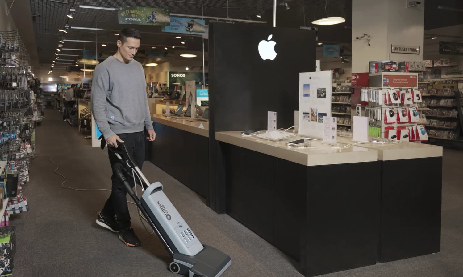 Nilfisk VU500 commercial upright vacuum operating in a retail store
