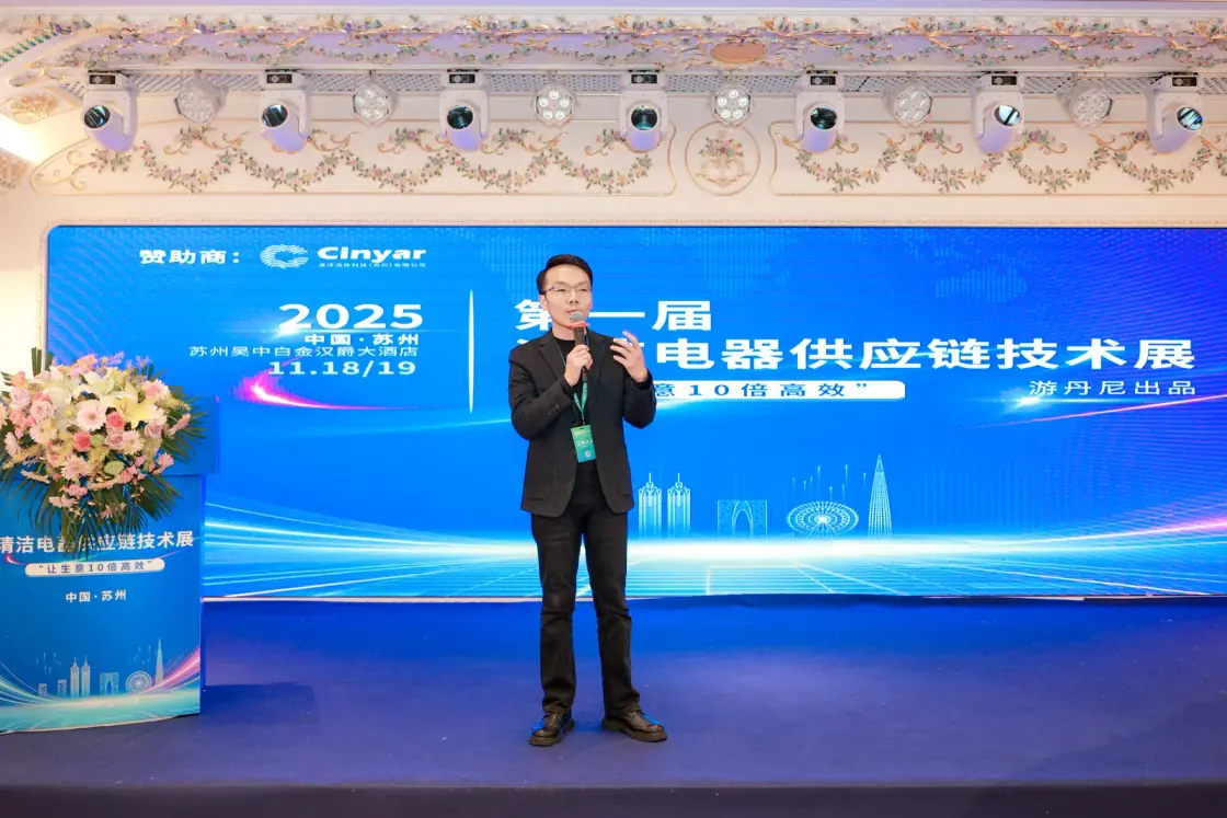November 2025 · Denny speaking on stage
