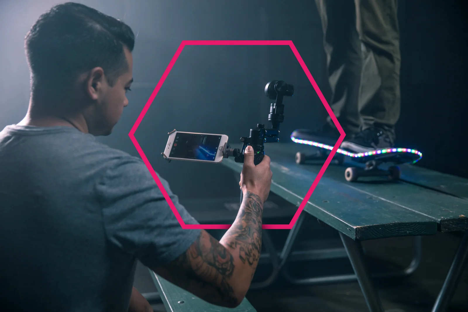 A filmmaker uses the original DJI Osmo and an attached smartphone to record a skateboarder.