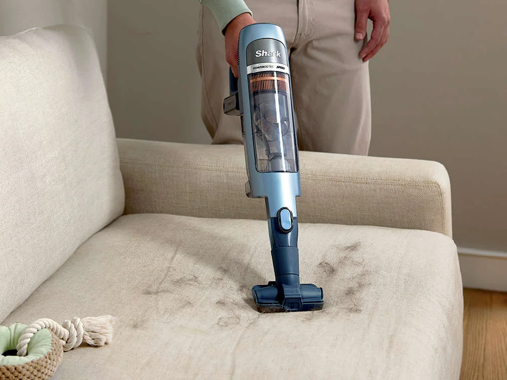Official Shark IA3241 hand vacuum cleaning upholstery with its attachment