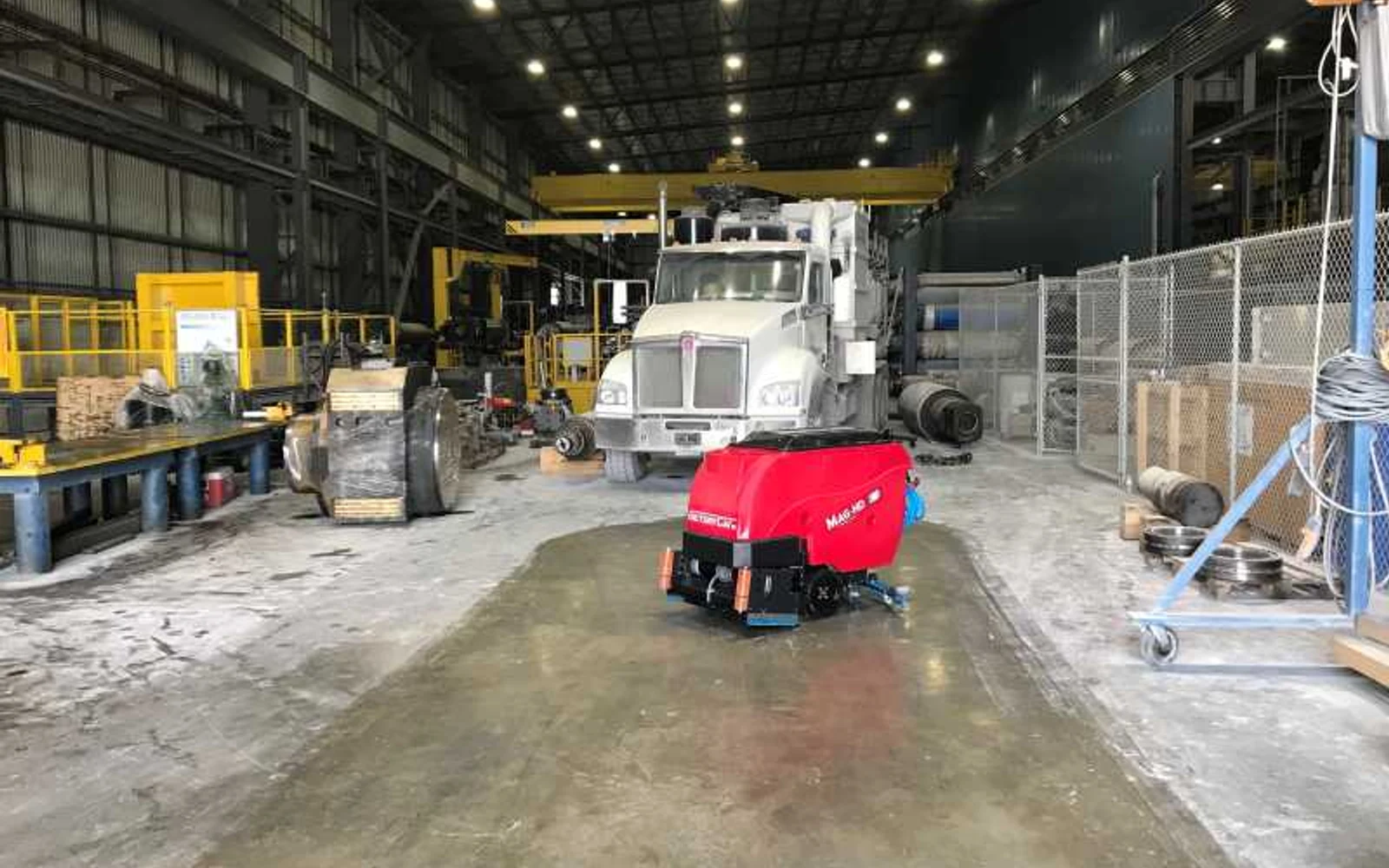 Factory Cat MAG-HD scrubber cleaning an industrial vehicle-service floor