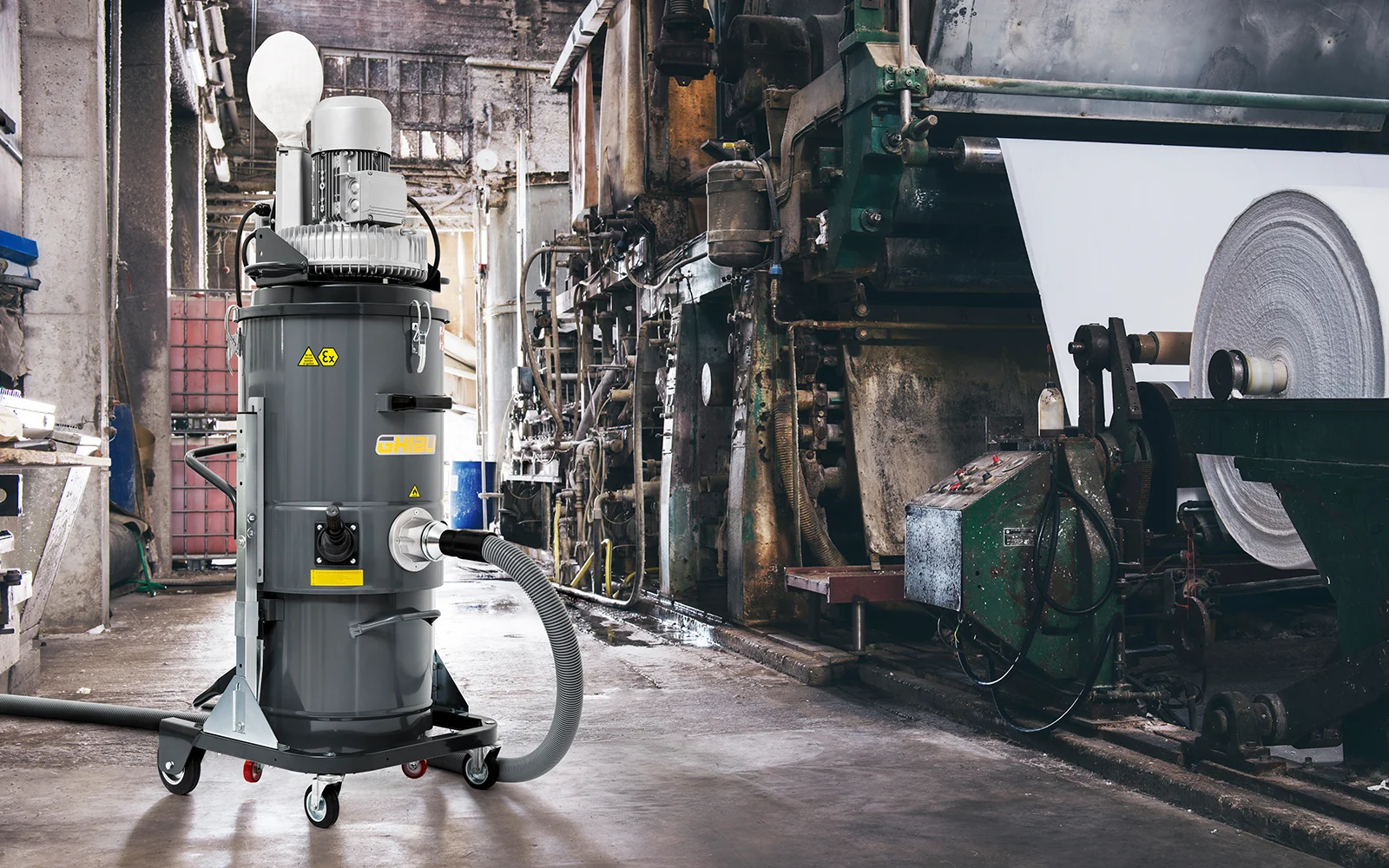 Ghibli industrial vacuum positioned beside paper-production machinery