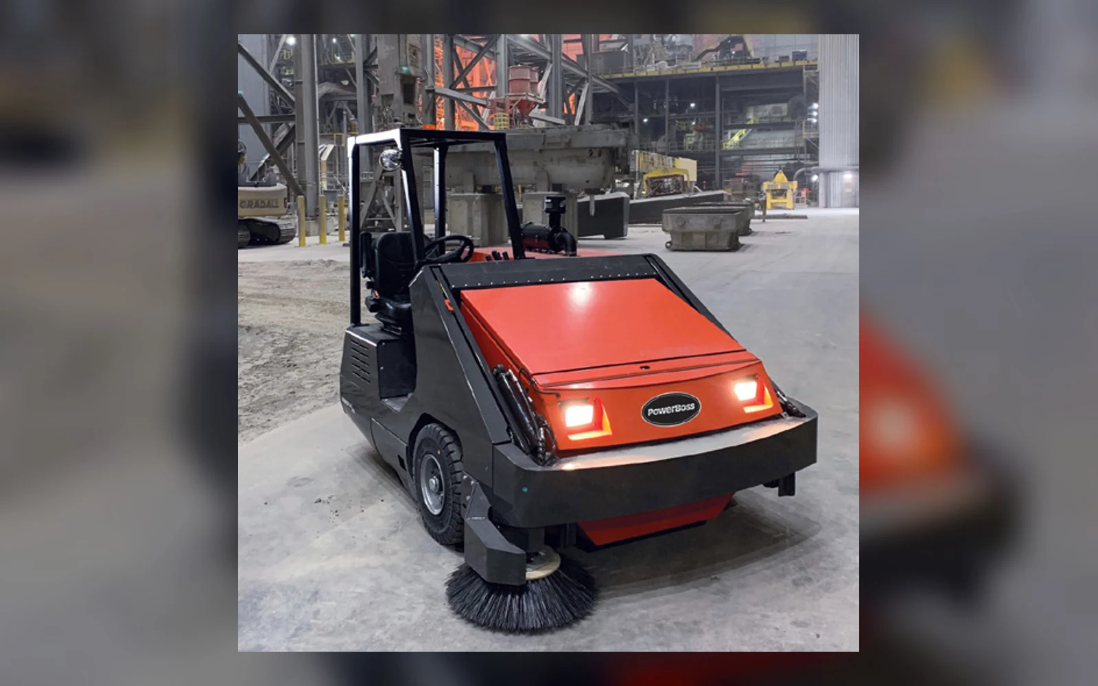 PowerBoss Armadillo industrial sweeper at a heavy manufacturing site
